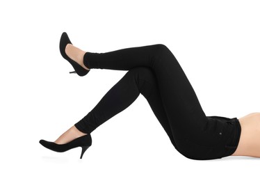 Woman wearing stylish black jeans and high heels shoes on white background, closeup
