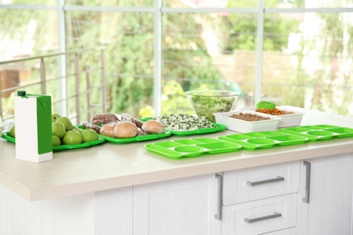 Dishes and trays with food for poor on table indoors