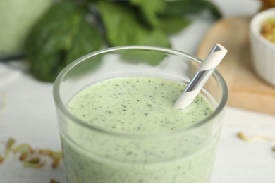 Photo of Green buckwheat smoothie on white table, closeup