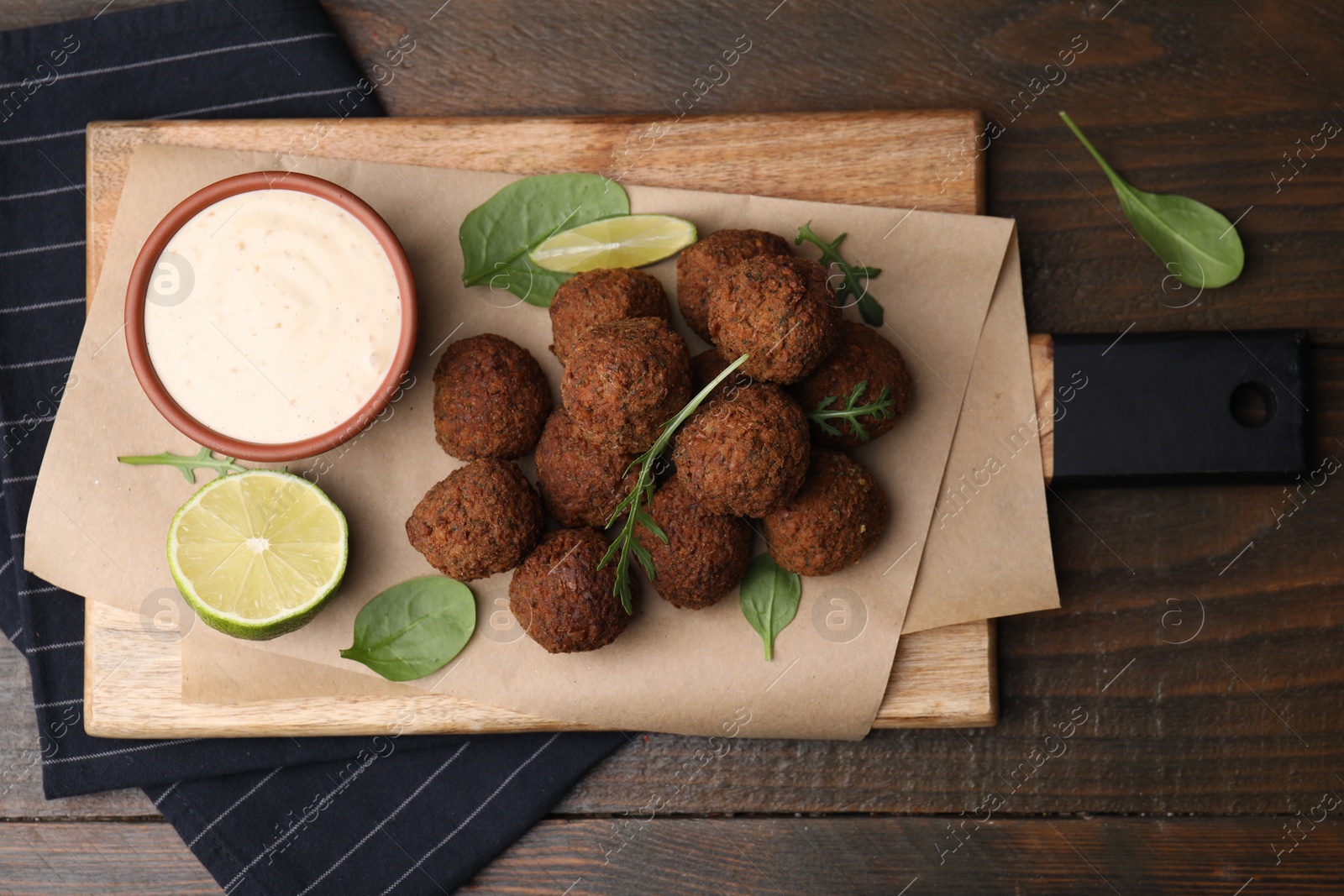 Photo of Delicious falafel balls served on wooden table, top view