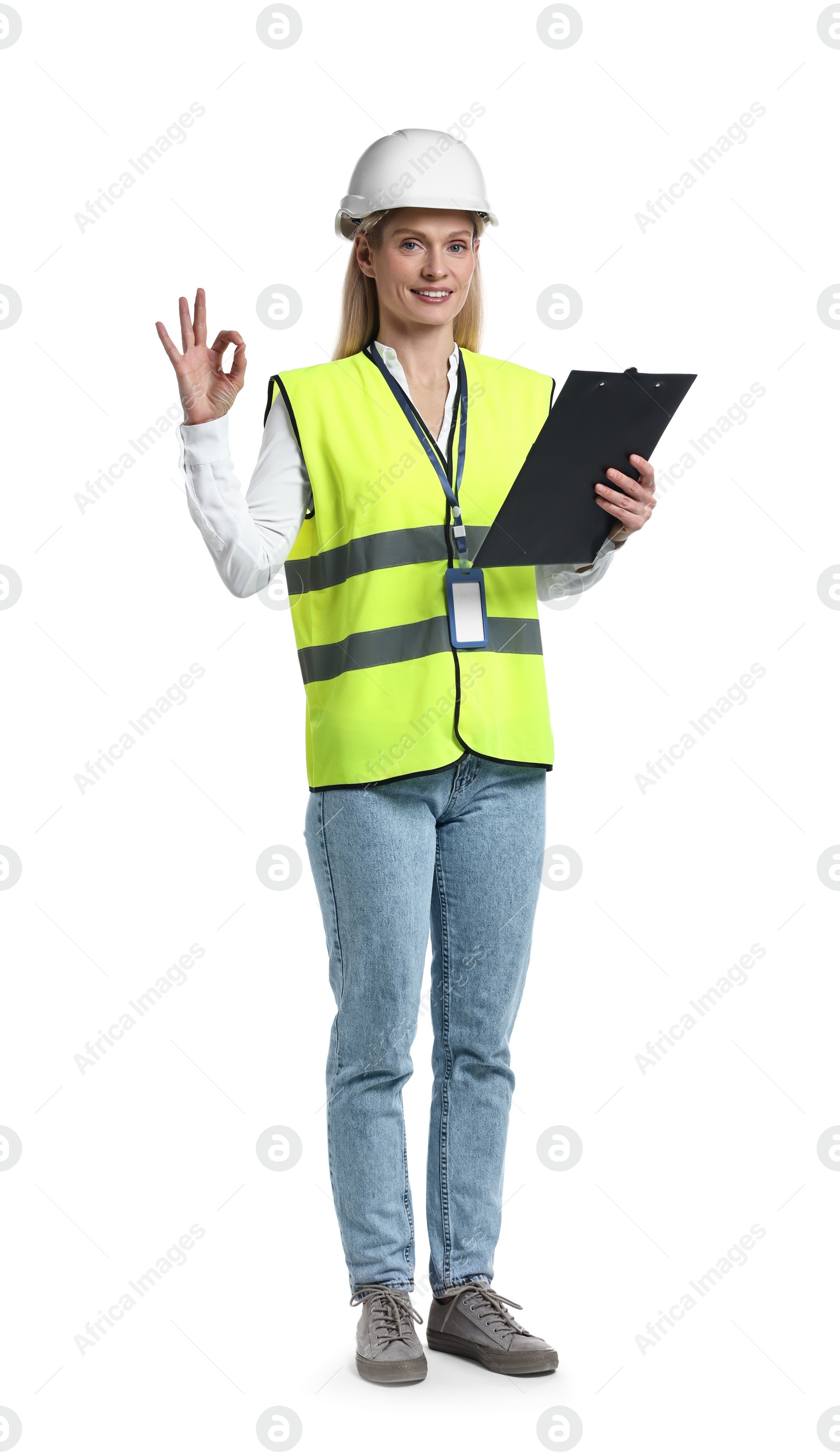 Photo of Engineer in hard hat holding clipboard and showing ok gesture on white background