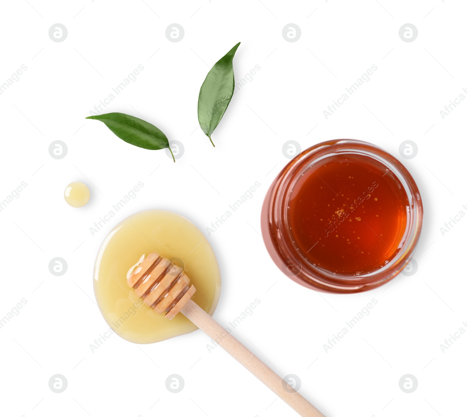 Photo of Tasty natural honey, glass jar, dipper and green leaves on white background, top view