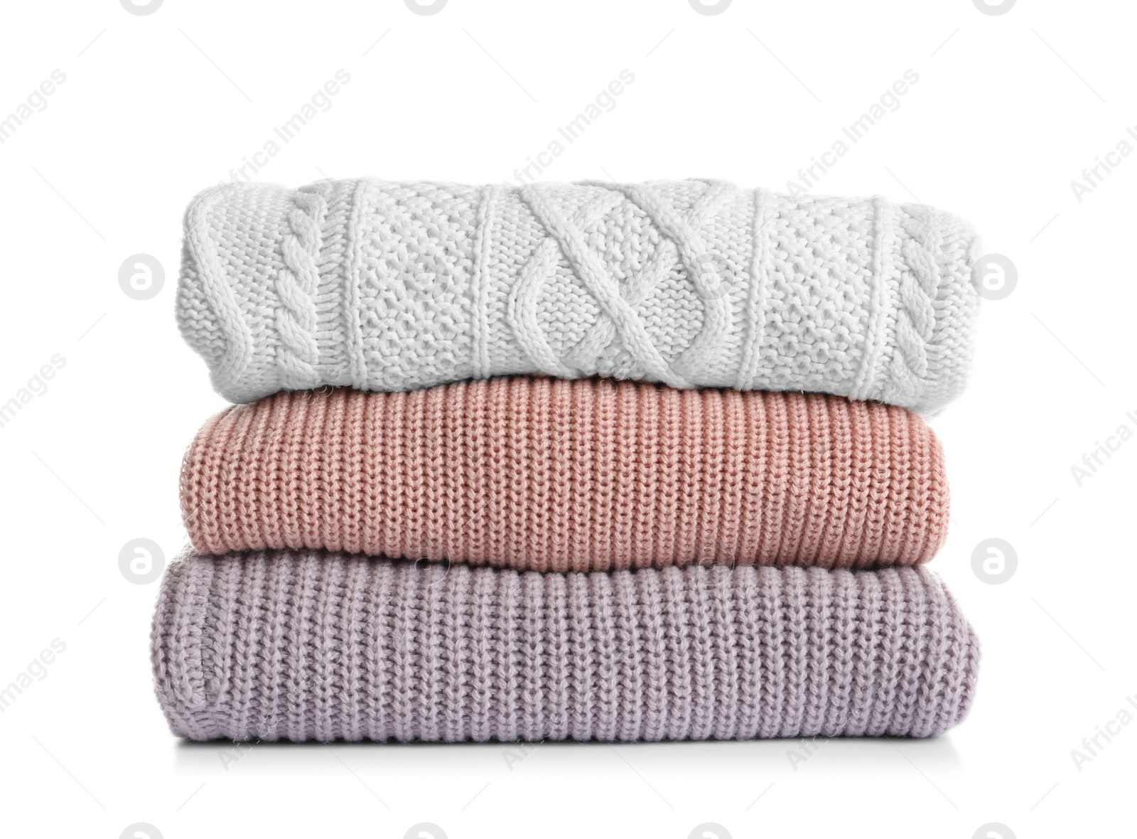 Photo of Stack of warm knitted clothes on white background