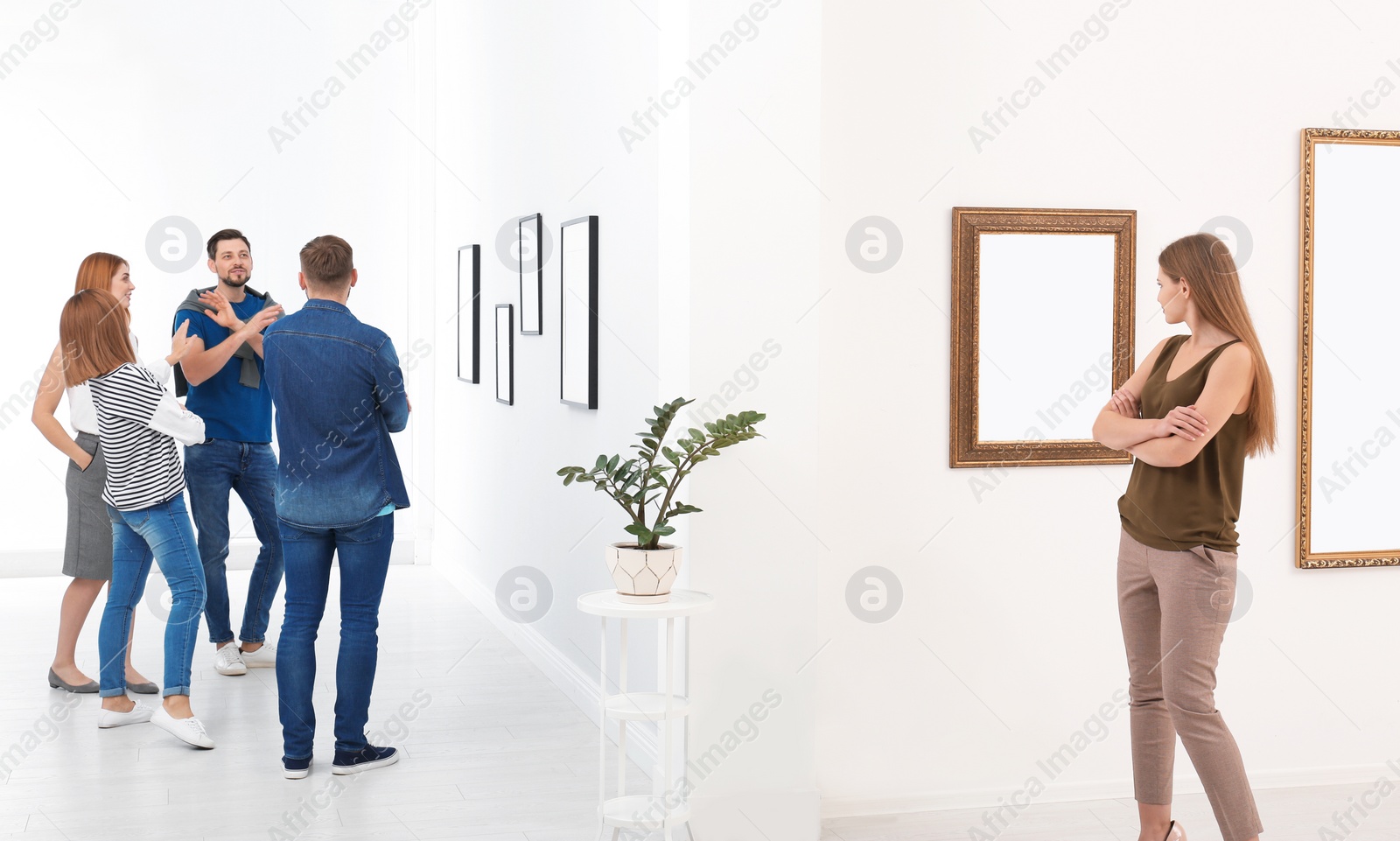 Photo of People viewing exposition in modern art gallery