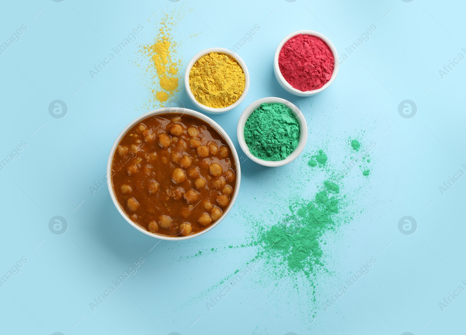 Photo of Traditional Indian food and color powder dyes on turquoise background, flat lay. Holi festival