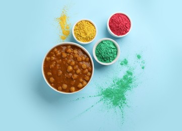 Photo of Traditional Indian food and color powder dyes on turquoise background, flat lay. Holi festival