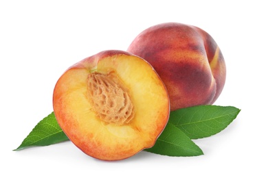 Sweet juicy peaches with leaves on white background