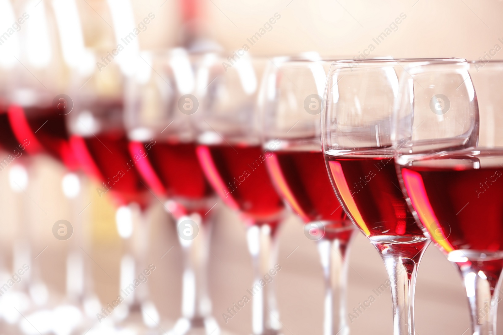 Photo of Glasses with delicious red wine, closeup