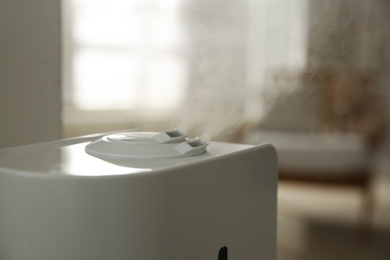 Photo of Modern humidifier on blurred background, closeup view