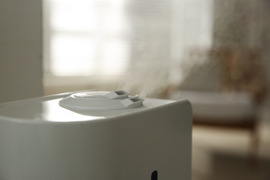 Modern humidifier on blurred background, closeup view