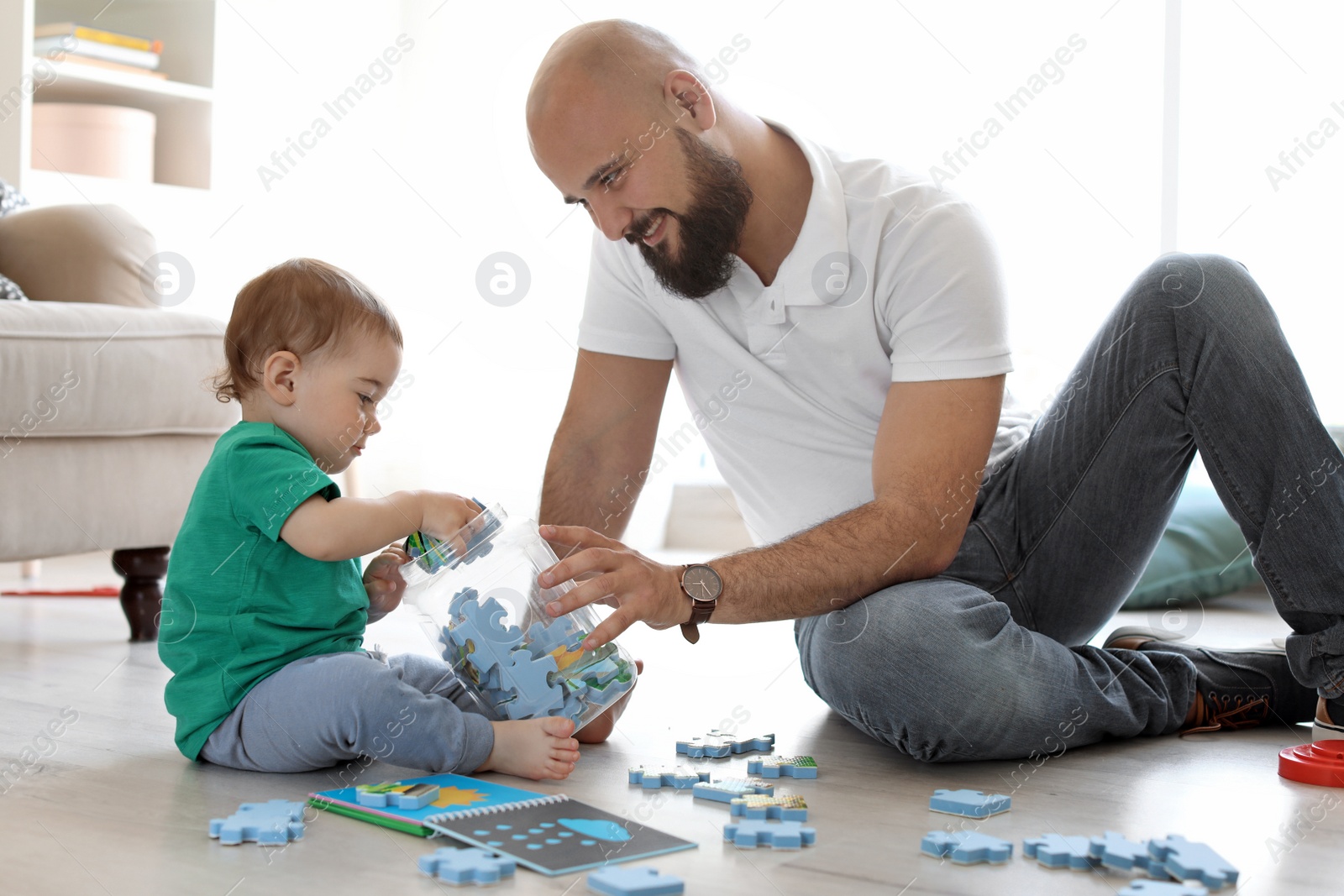 Photo of Dad and his little son playing together at home