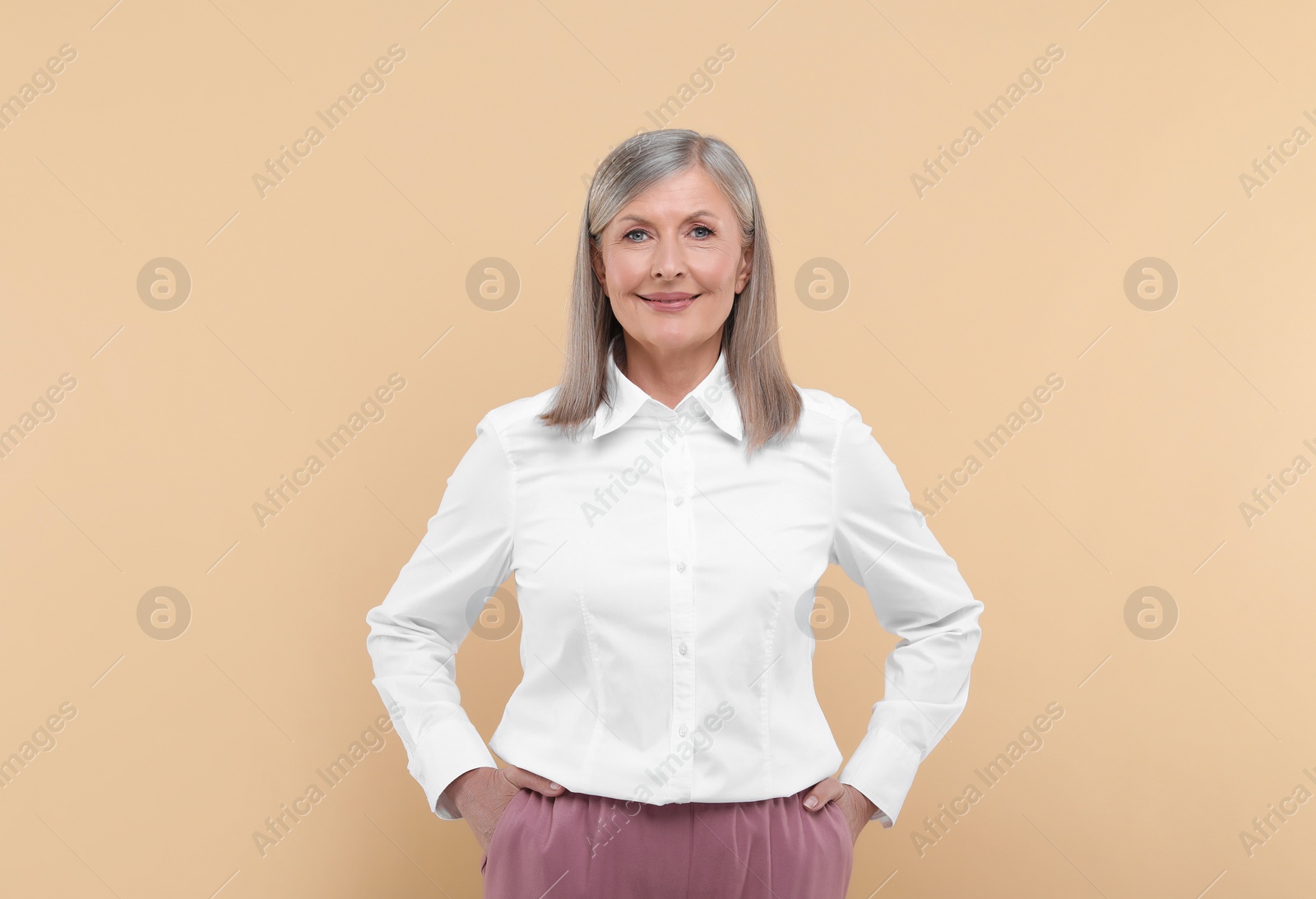 Photo of Portrait of beautiful senior woman on beige background