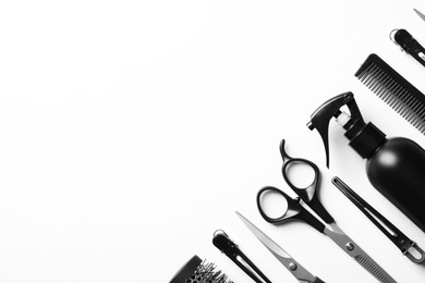 Photo of Composition with scissors and other hairdresser's accessories on white background, top view