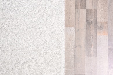 Photo of Light soft carpet on wooden floor