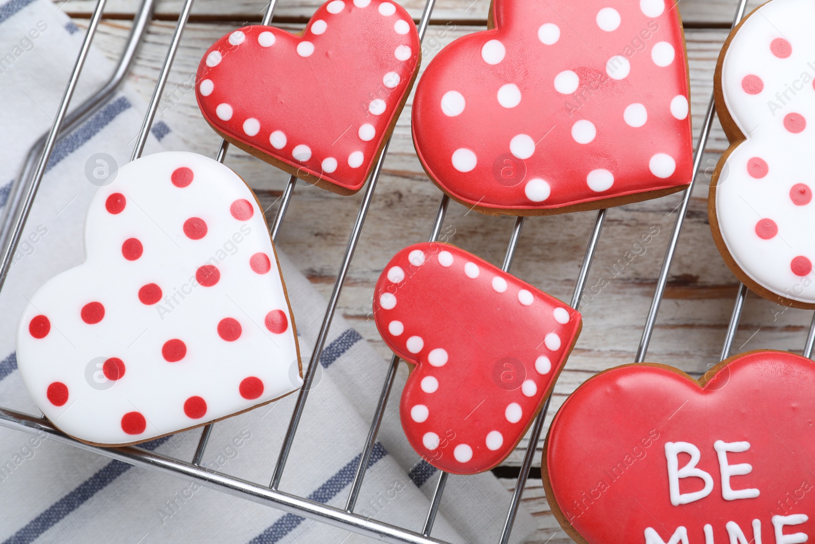 Photo of Decorated heart shaped cookies on white wooden table, flat lay. Valentine's day treat