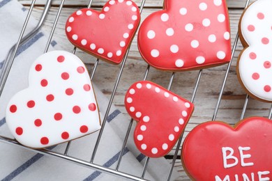 Decorated heart shaped cookies on white wooden table, flat lay. Valentine's day treat