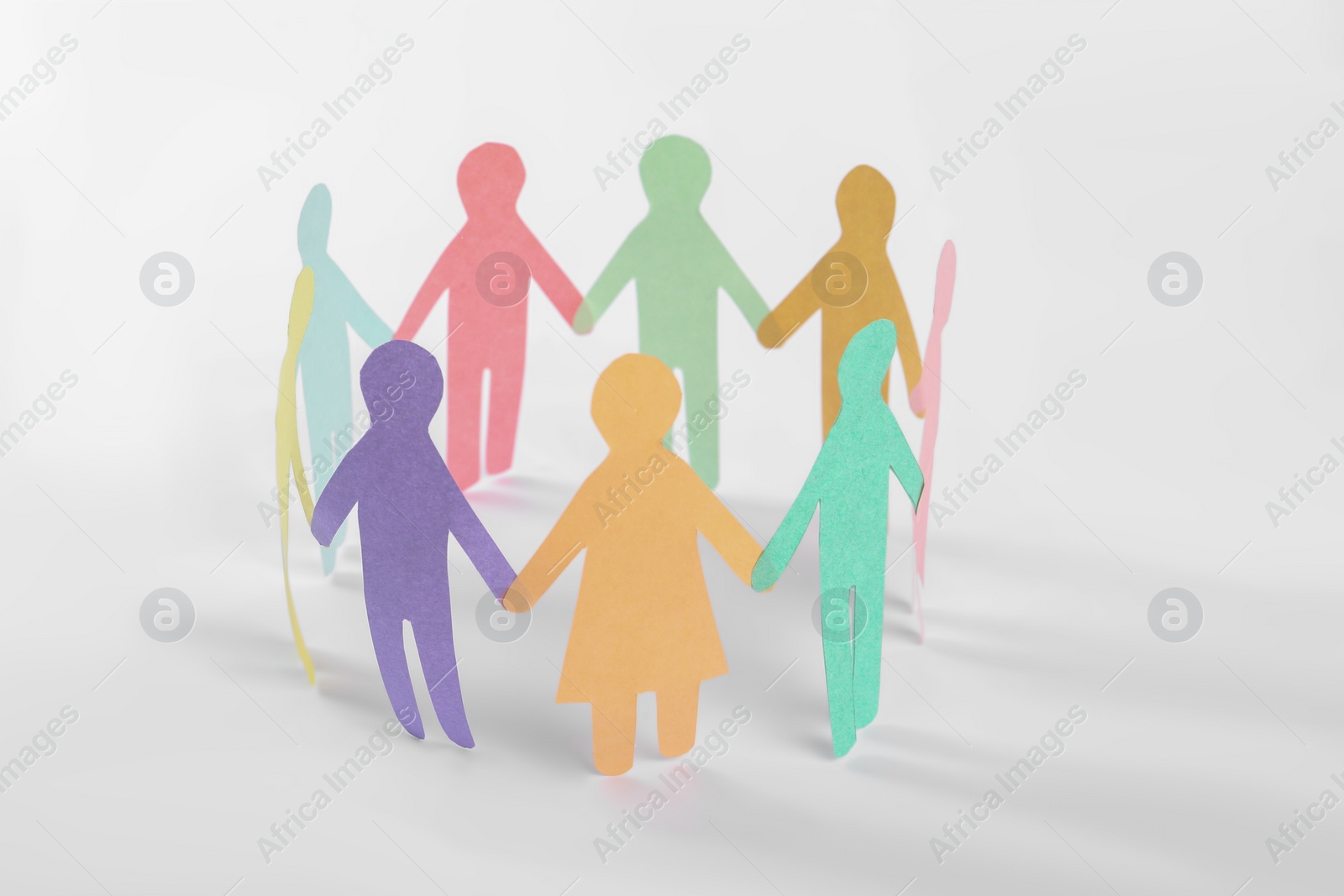 Photo of Paper human figures making circle on white background. Diversity and Inclusion concept