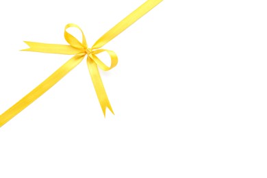 Yellow satin ribbon with bow on white background, top view