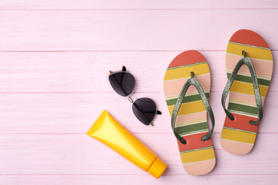 Photo of Beach objects on pink wooden background, flat lay