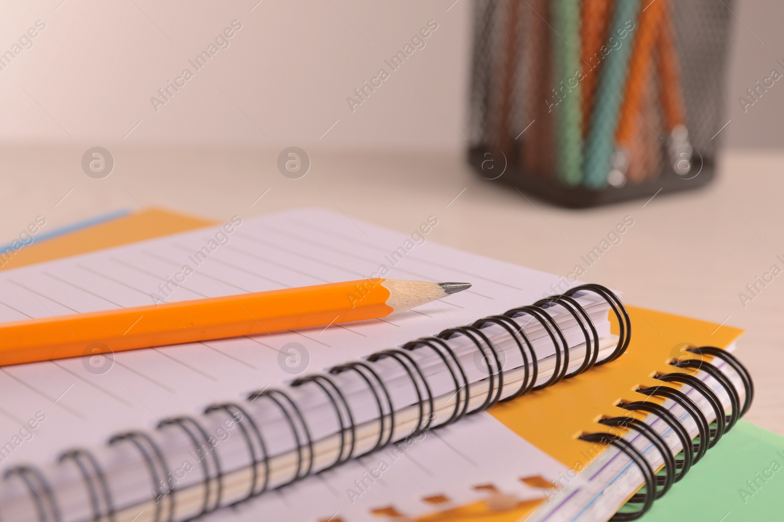 Photo of Closeup view of notebooks and pencil at workspace