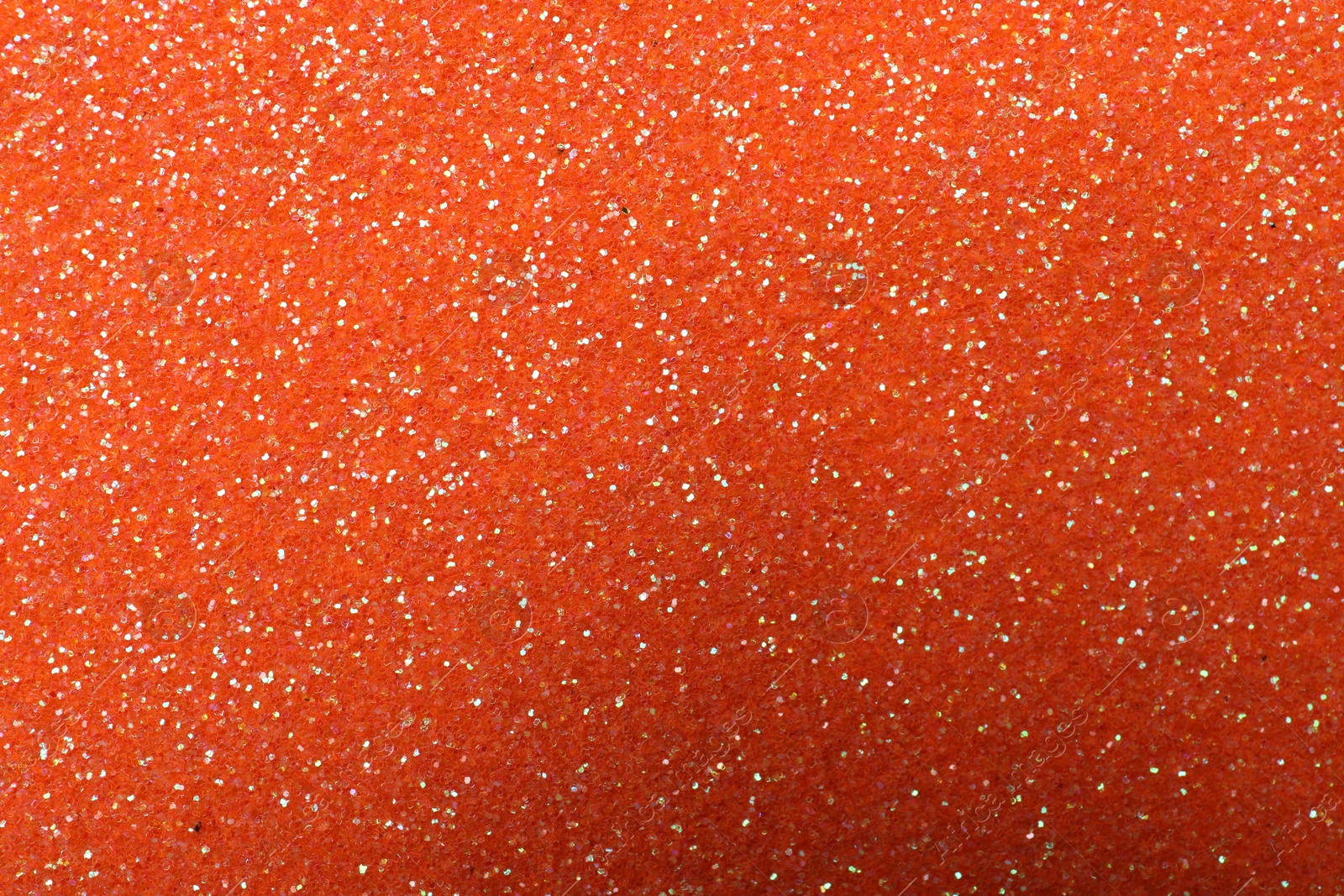 Photo of Beautiful shiny orange glitter as background, closeup
