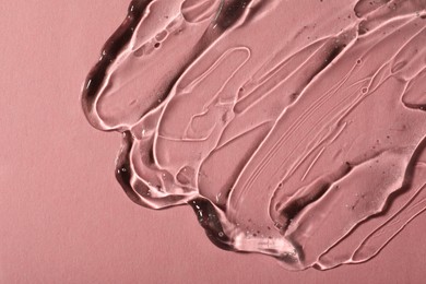 Photo of Transparent cosmetic gel on pink background, top view