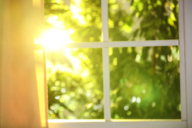 Blurred view through window on garden in morning