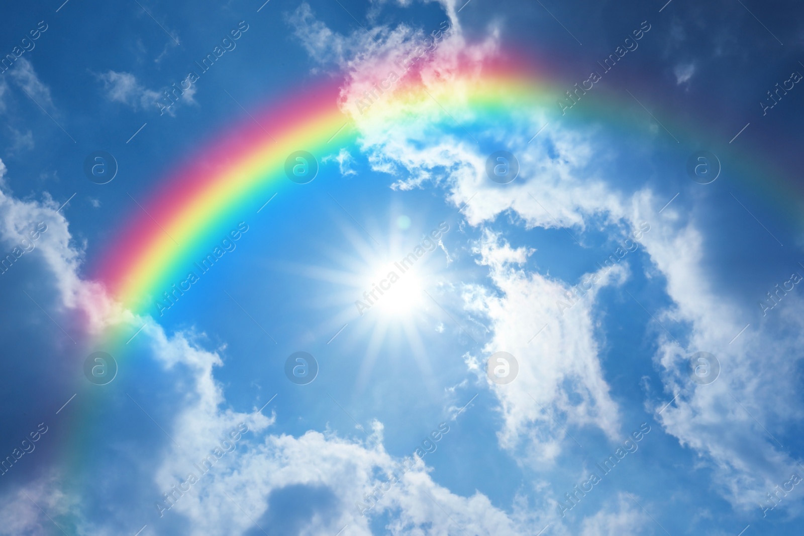 Image of Picturesque view of beautiful rainbow and blue sky on sunny day 