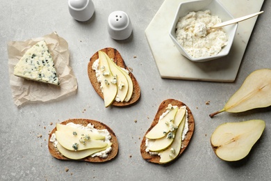 Photo of Bruschettas with pear served on table, flat lay