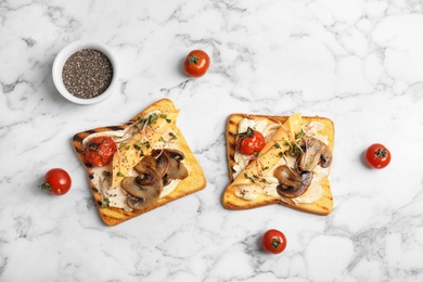 Photo of Flat lay composition with tasty toasts, cherry tomatoes and chia seeds on marble background