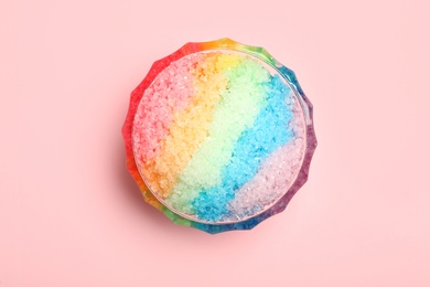 Photo of Rainbow shaving ice in glass dessert bowl on light background, top view