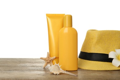 Sun protection products and beach accessories on wooden table