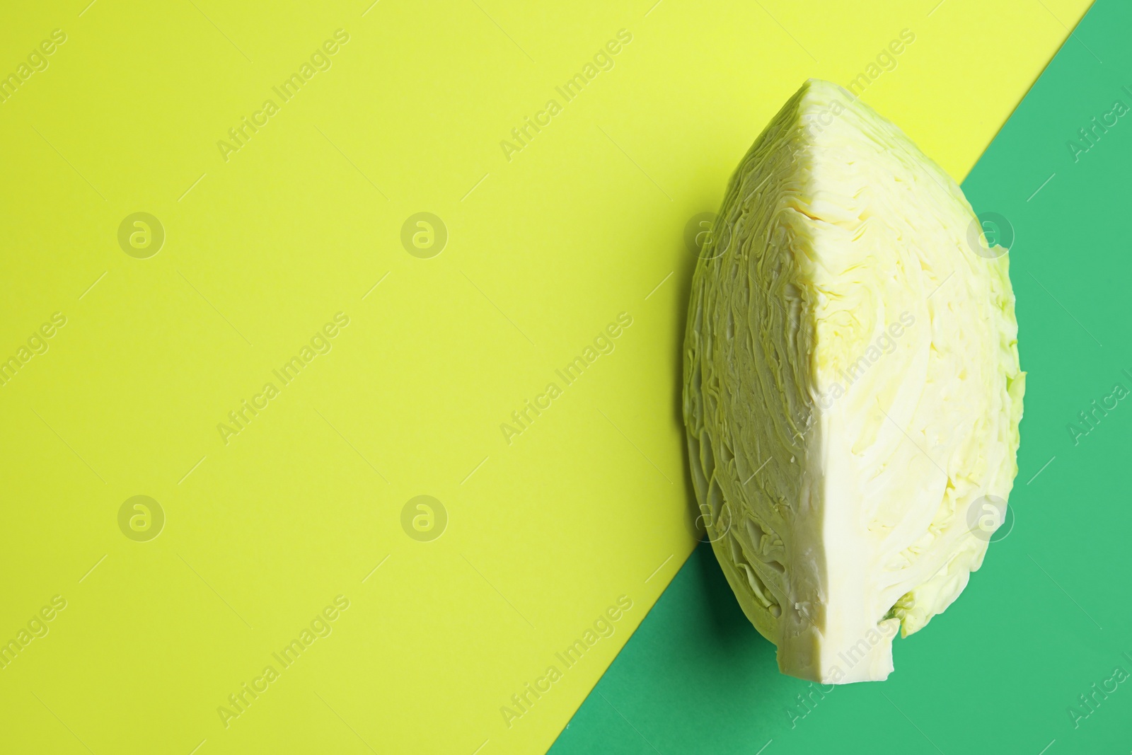 Photo of Cut ripe cabbage on color background, top view