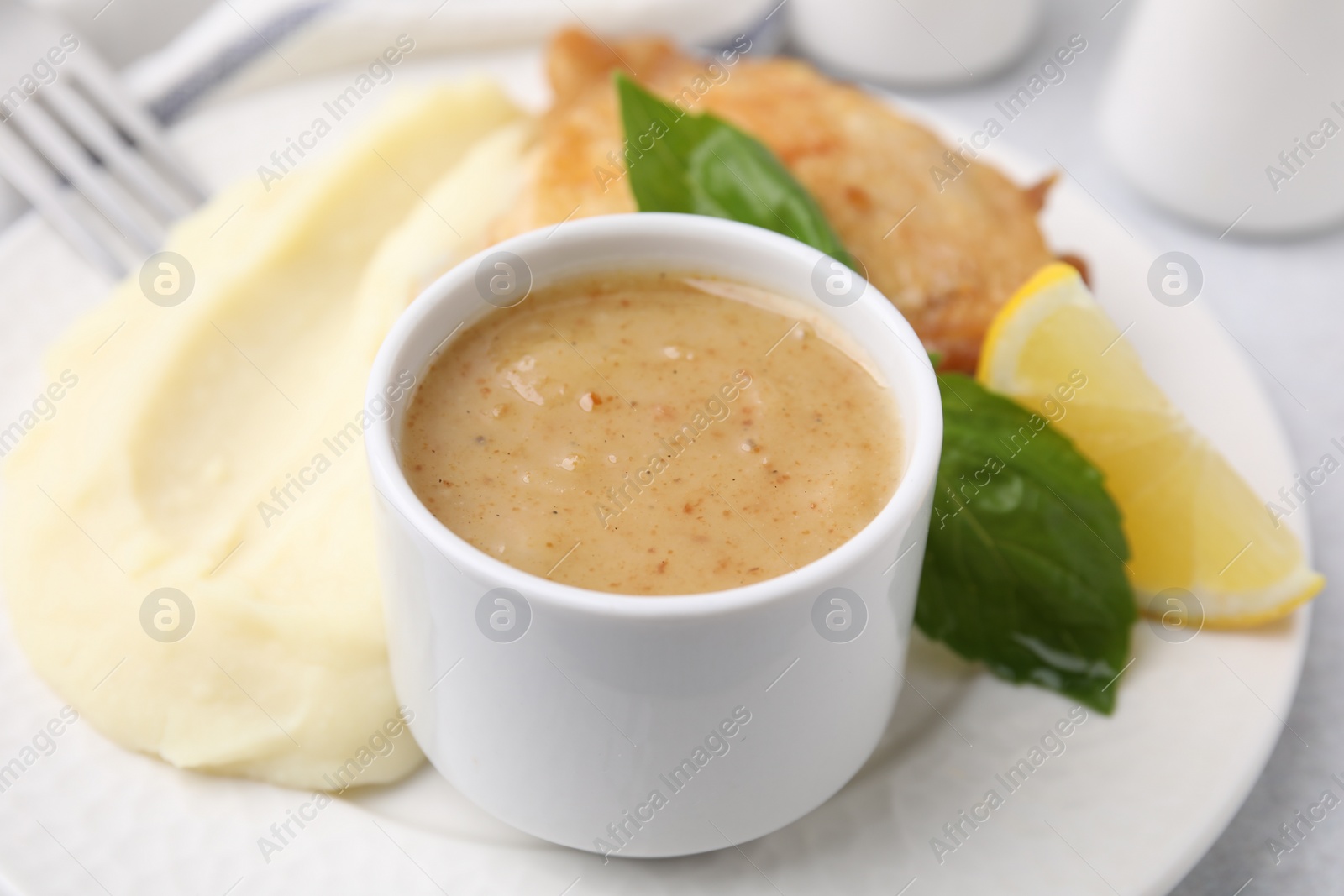 Photo of Delicious turkey gravy served on table, closeup