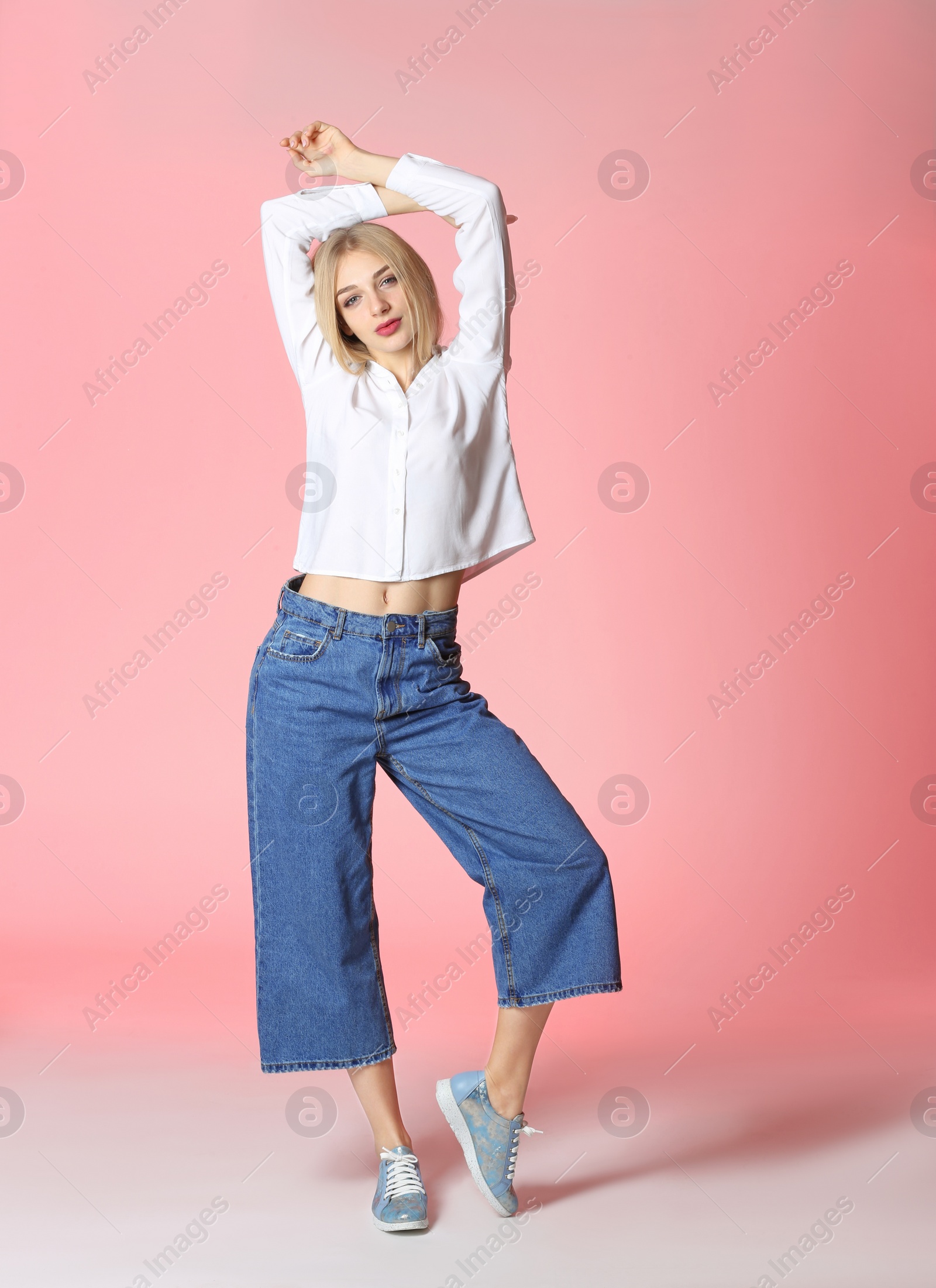Photo of Full length portrait of woman in stylish shoes on color background