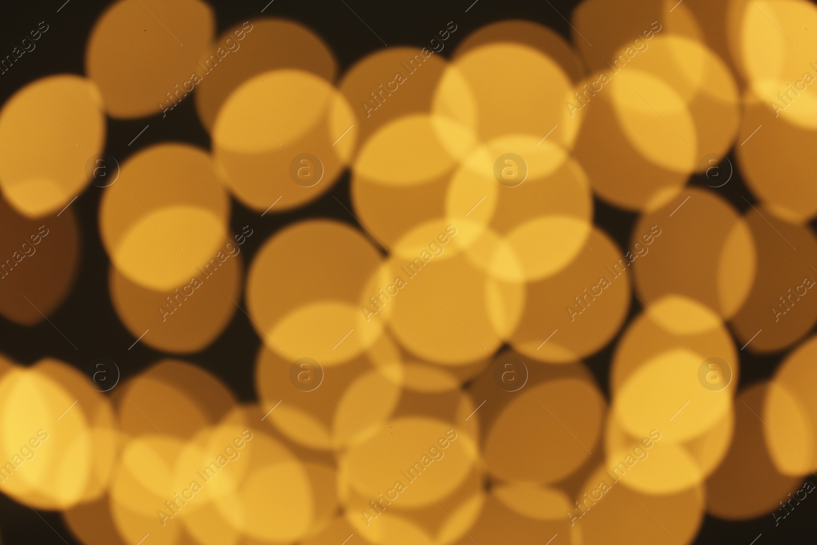 Photo of Beautiful golden lights on dark background. Bokeh effect