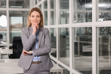 Photo of Female real estate agent indoors. Space for text