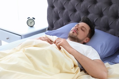 Photo of Handsome man sleeping on pillow at home. Bedtime