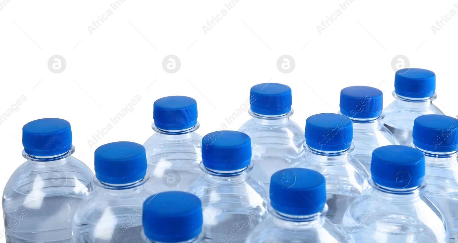 Photo of Rows of plastic bottles with pure water on white background