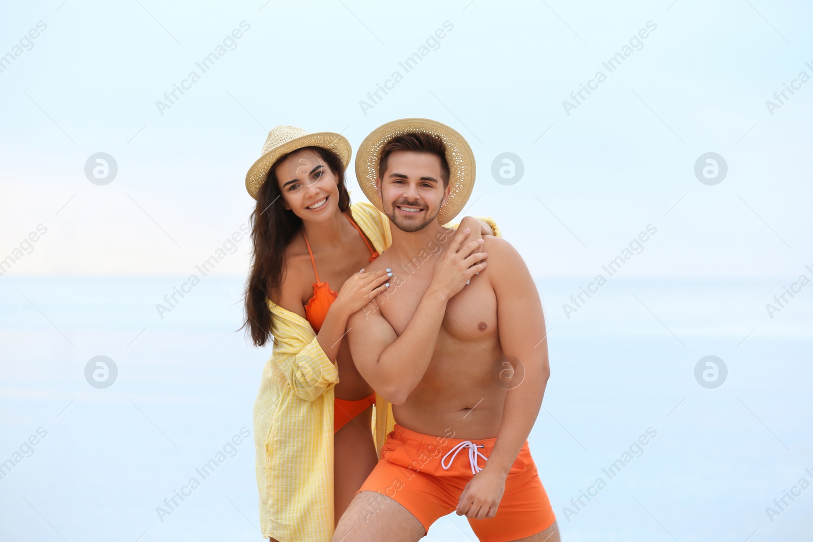 Photo of Happy young couple spending time together on beach