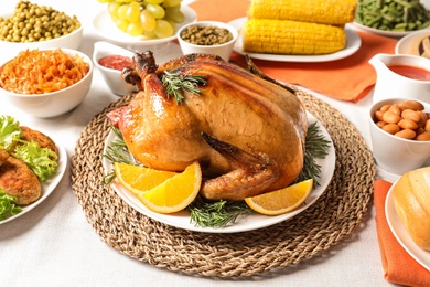 Photo of Delicious roasted turkey with garnish on dinner table