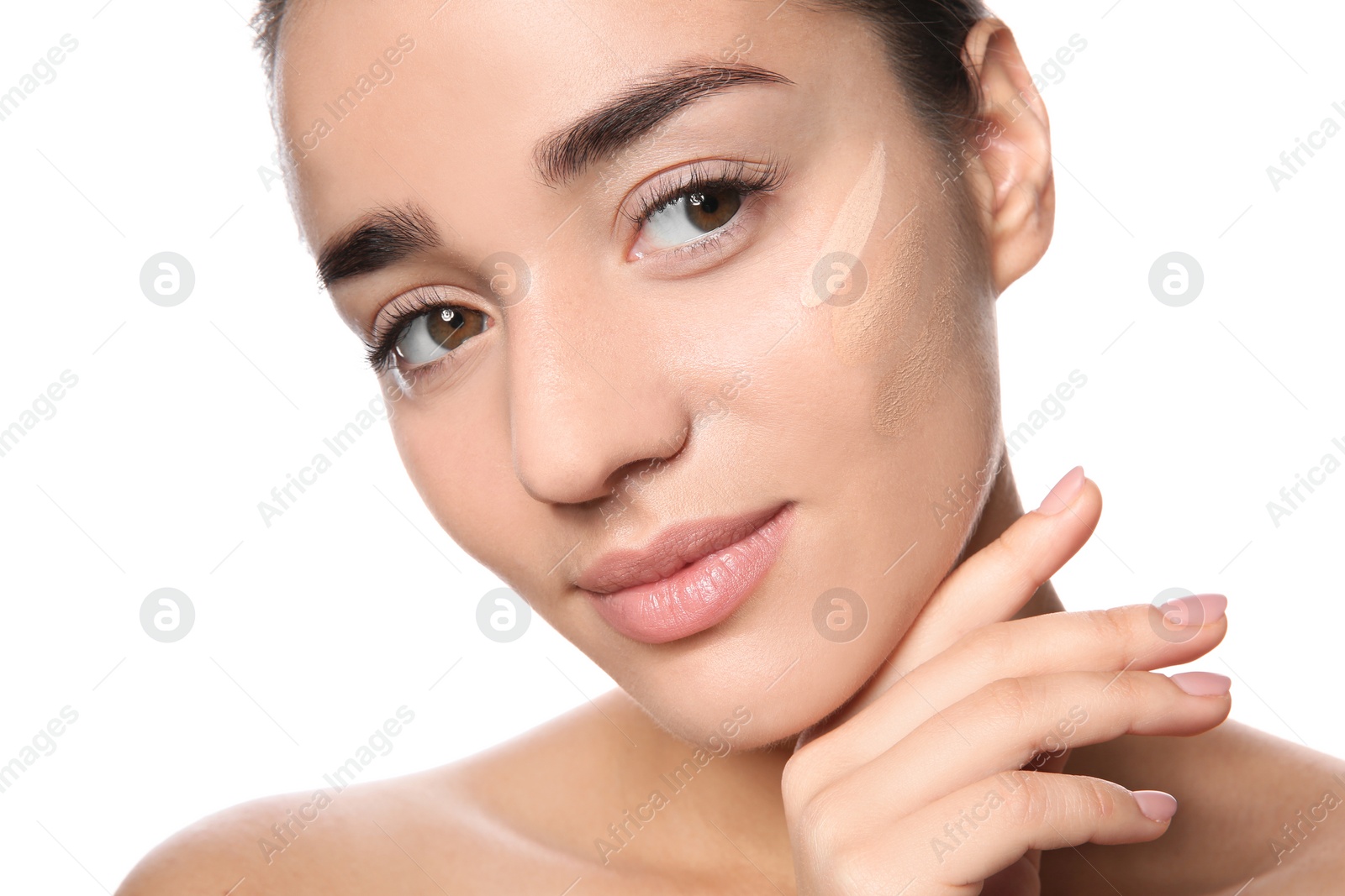 Photo of Young woman with different shades of skin foundation on her face against white background