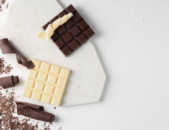 Photo of Flat lay composition with chocolate curls and space for text on light background