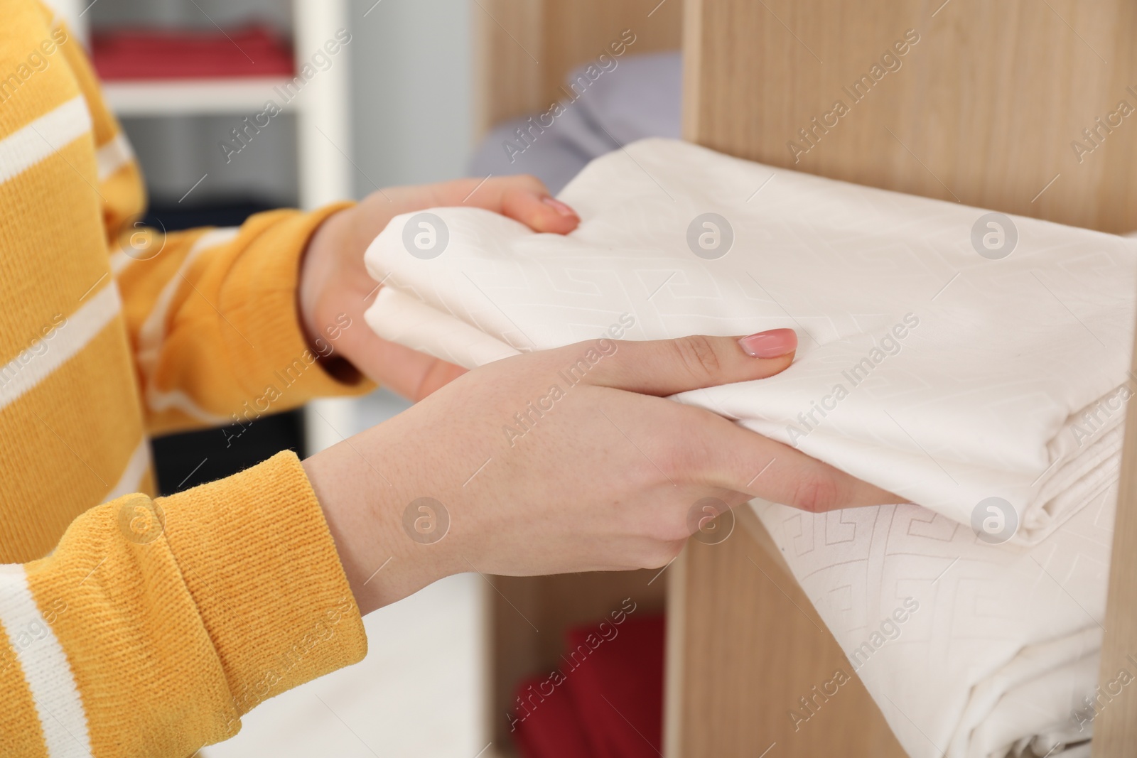 Photo of Woman with bed linens in shop, closeup