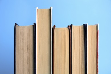 Collection of books on light blue background