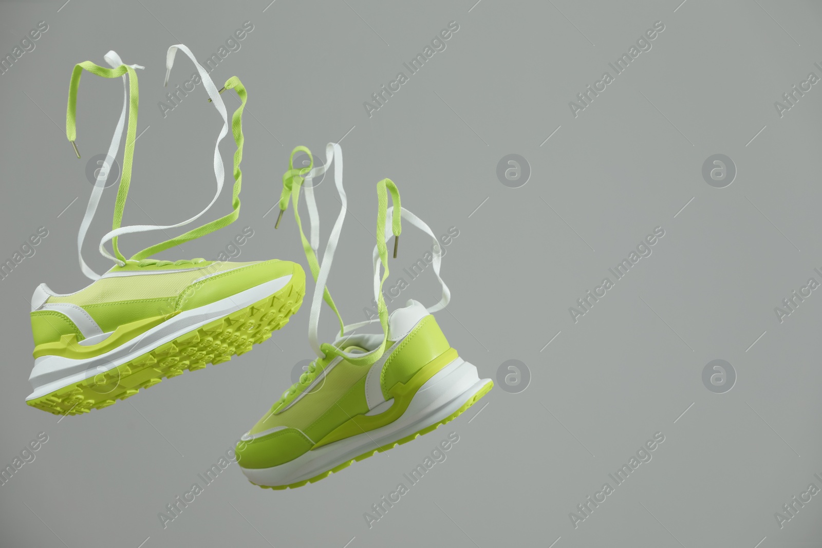 Photo of Pair of stylish sneakers on light grey background. Space for text