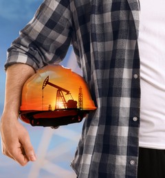 Double exposure of man with orange hard hat and crude oil pump