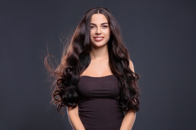 Portrait of beautiful model with gorgeous curly hair on black background