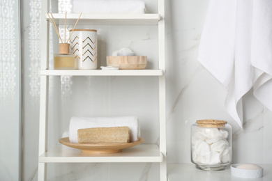 Shelving unit with different items in bathroom interior