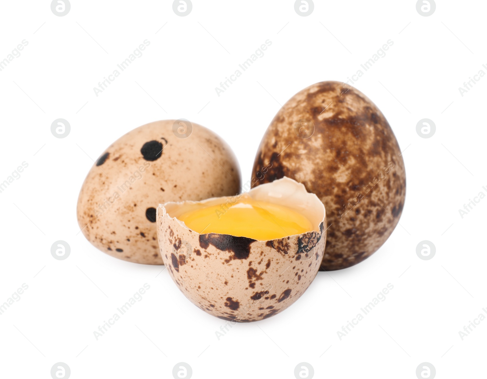 Photo of Whole and cracked quail eggs on white background